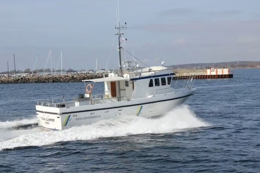 The Tunaclipper, a white boat, sails on the water, offering a 5-hour fishing trip from Varberg.
