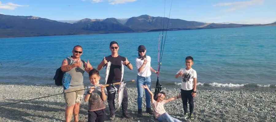 Family fishing trip by mountain lake