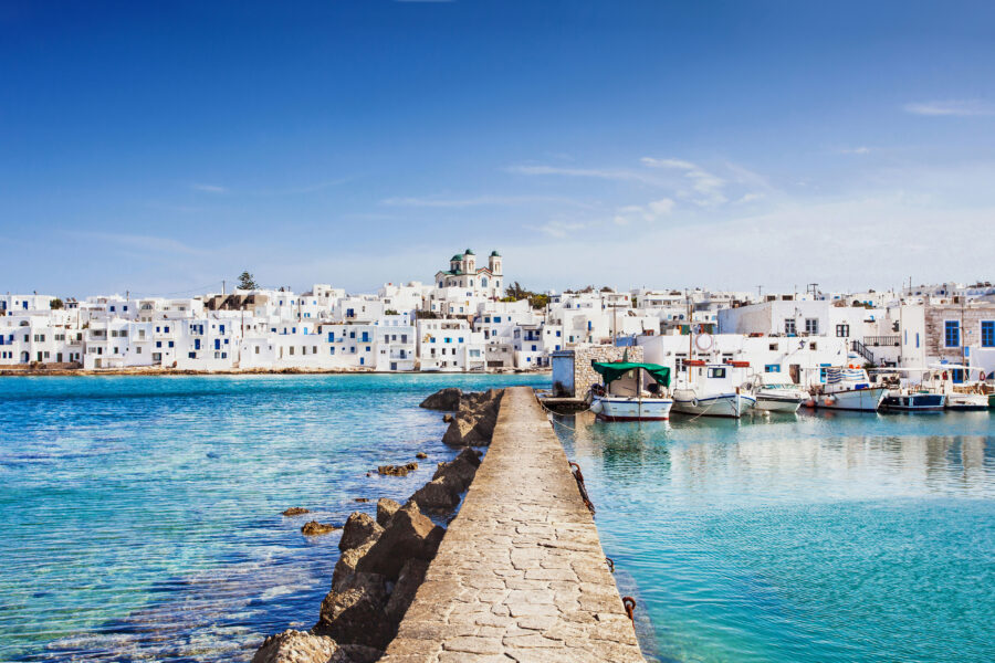 Naousa, a quaint fishing village in Paros, Greece, with its iconic white buildings and serene waterfront atmosphere.
