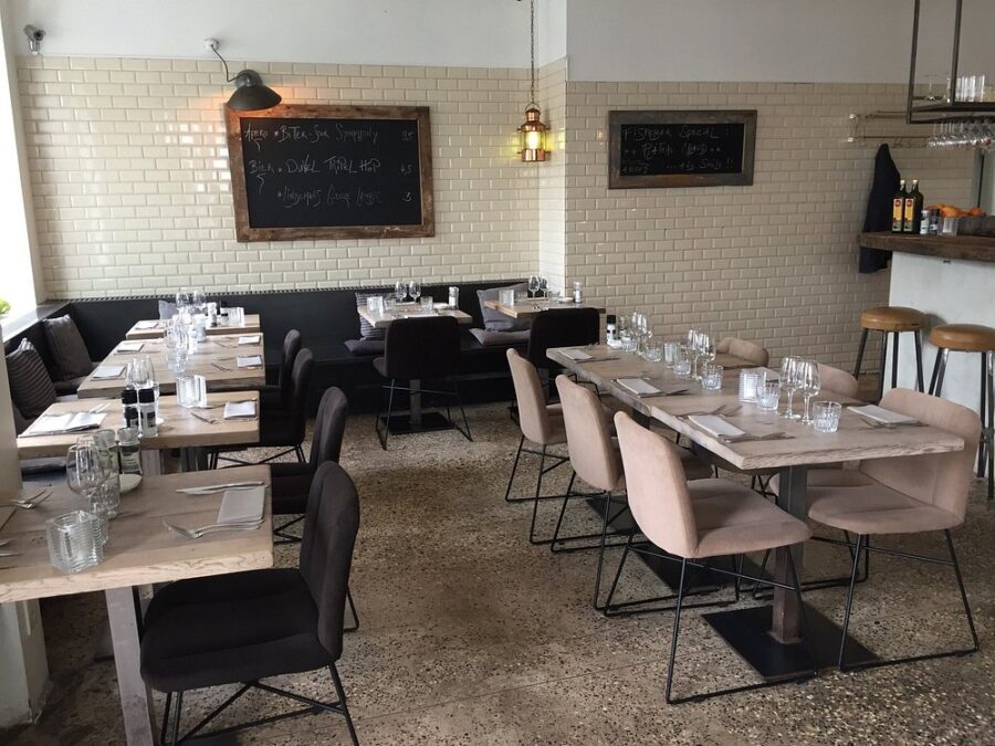 Fiskebar restaurant in Antwerp featuring tables and chairs arranged in the center of a cozy dining area.
