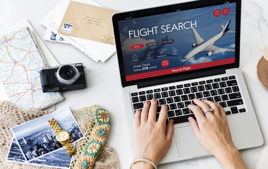 Online flight booking interface with travel items and a woman planning a trip.