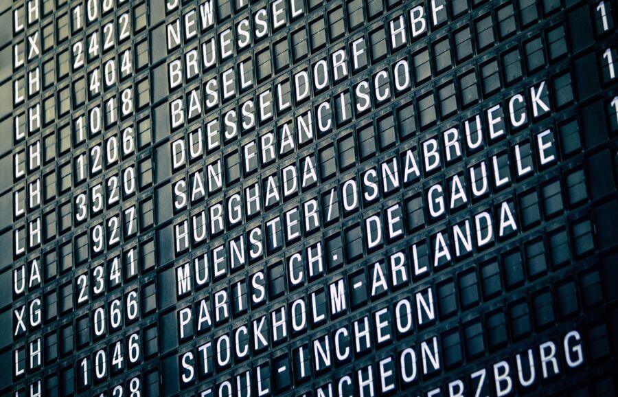 Airport flight information board displaying destinations and flight numbers in clear, readable format.