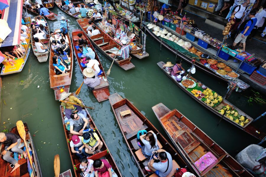 Floating market in Damnoen Saduak, Bangkok, Thailand, showcasing colorful boats and vibrant local produce
