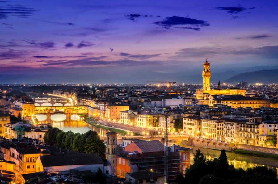 Scenic night view of Florence featuring the lit Ponte Vecchio and Palace, highlighting the city's architectural beauty