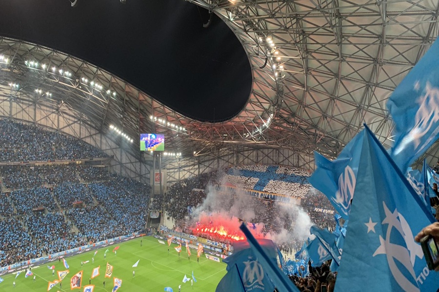 Fans celebrate passionately at an Orange Vélodrome  during a thrilling match.