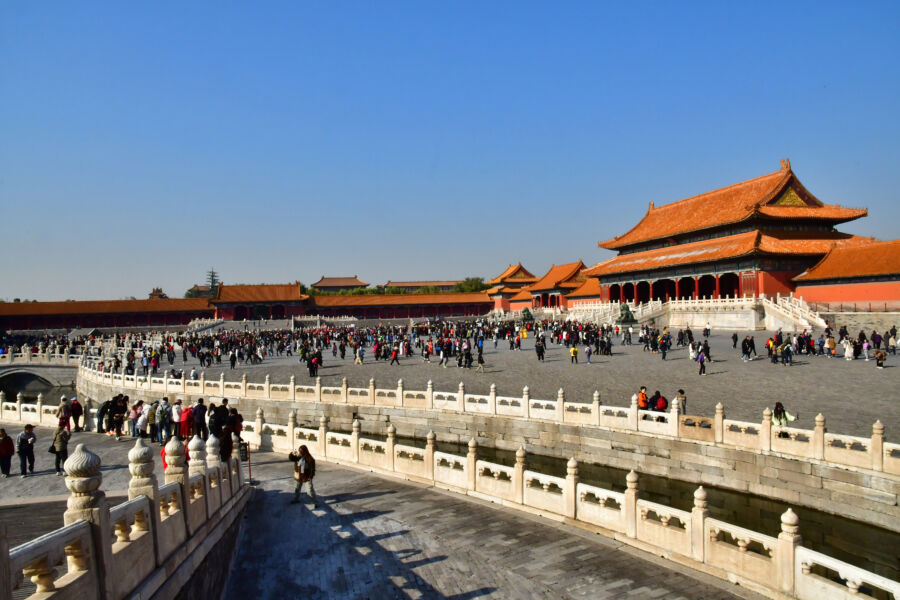 Panoramic view of the Forbidden City in China, showcasing tourists exploring the historic architecture