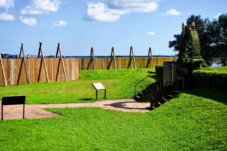 Fort Caroline National Memorial shows a reconstructed stockade wall of the French colonial settlement on the St. Johns River.