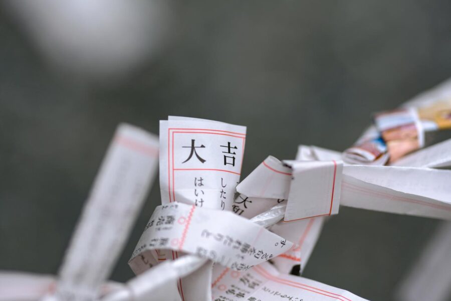 Omikuji Japanese fortune slips tied on cord showing Daikichi (great luck).