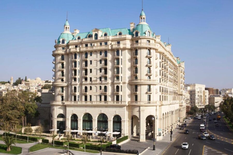 Four Seasons Hotel Baku in Baku, Azerbaijani, showcasing its elegant architecture and luxurious ambiance against a clear blue sky.