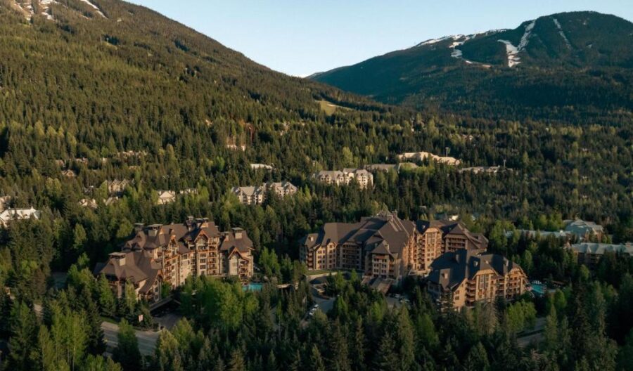 The Four Seasons Resort lodge at Whistler Mountain, surrounded by snow-capped peaks in British Columbia, Canada.