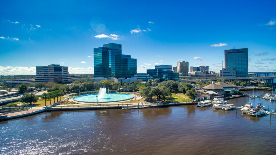 Panoramic aerial shot of Jacksonville, Florida, featuring the Friendship Fountain and the stunning city skyline.
