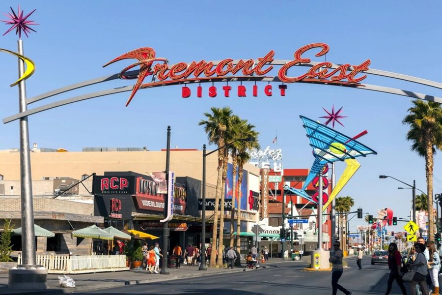 Vibrant Fremont East District scene in Las Vegas with retro neon signs and lively atmosphere.