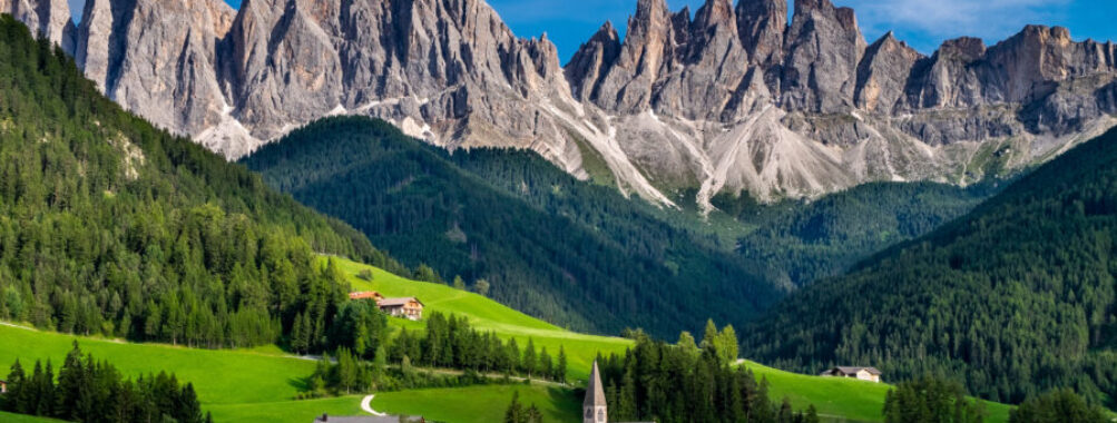 The picturesque St. Magdalena Church set against the towering Odle mountain range in Funes Valley, Dolomites, Italy