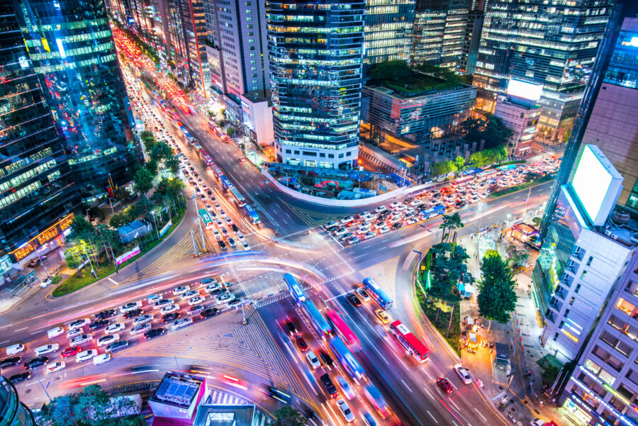Night aerial view of Gangnam District in Seoul, South Korea, showcasing a vibrant skyline illuminated by city lights