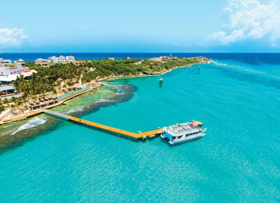 The deep blue ocean surrounds a central pier at Garrafon Natural Reef Park, located in Isla Mujeres, Mexico.
