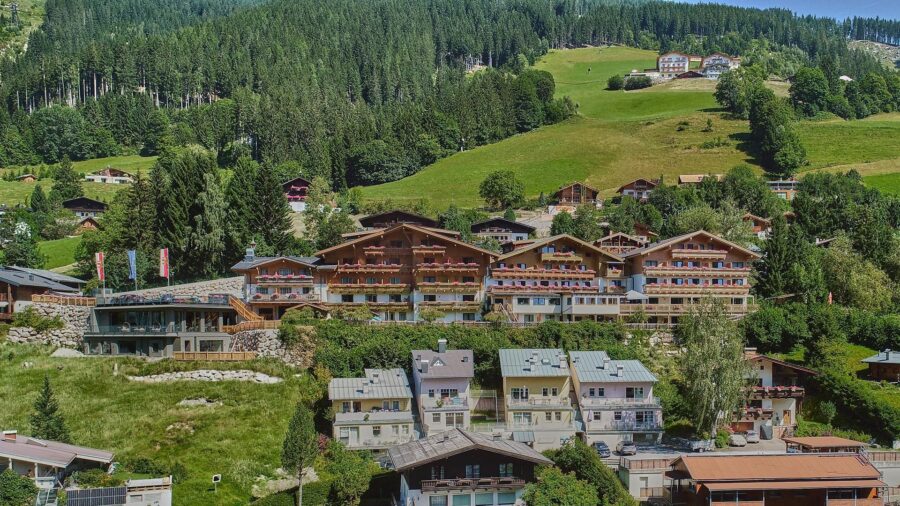 Exterior of Gartenhotel Daxer, showcasing modern architecture amidst lush greenery in Zell am See