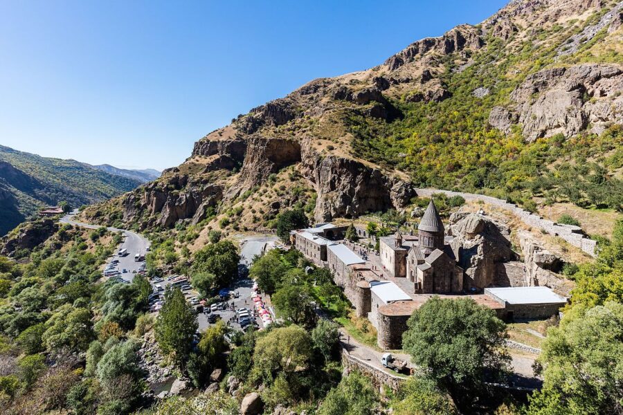 Geghard Monastery nestled in the mountains of Armenia, showcasing ancient stone architecture and natural beauty.
