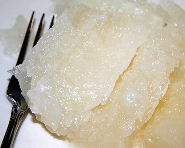 Close-up of Nordic lutefisk, showing gelatinous texture, shiny surface