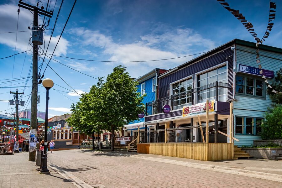 George Street in St Johns, showcasing a few buildings and pedestrians strolling along the sidewalk.
