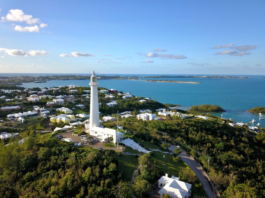 Aerial view of Bermuda islands featuring the Gibbs Hill Lighthouse amidst lush greenery and turquoise waters.