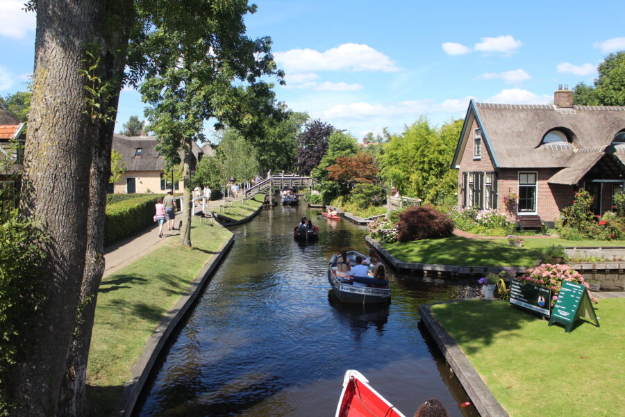 Scenic view of Giethoorn's old town with charming canals and traditional thatched-roof houses