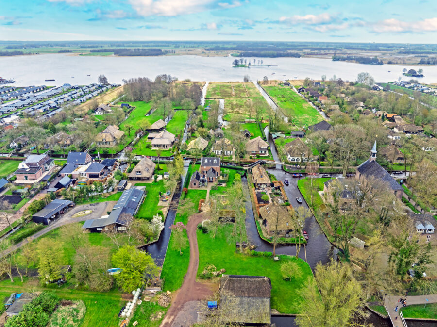 Aerial view of the picturesque village of Giethoorn in the Netherlands, showcasing its canals and thatched-roof houses