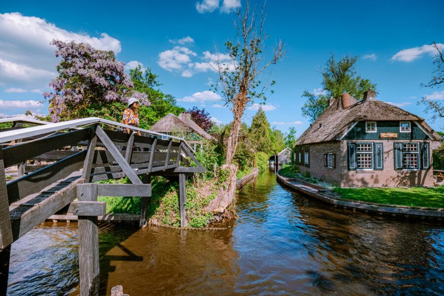 Typical Giethoorn houses with vibrant gardens, reflecting the beauty of the Netherlands
