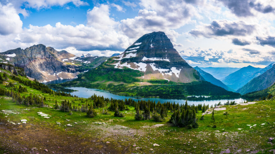 Scenic view of a hidden lake and mountains in Glacier National Park, Montana, captured on a cloudy day