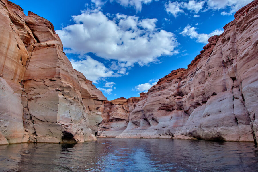 Narrow canyon with steep cliffs viewed from a boat in Glen Canyon National Recreation Area, Lake Powell, Arizona.
