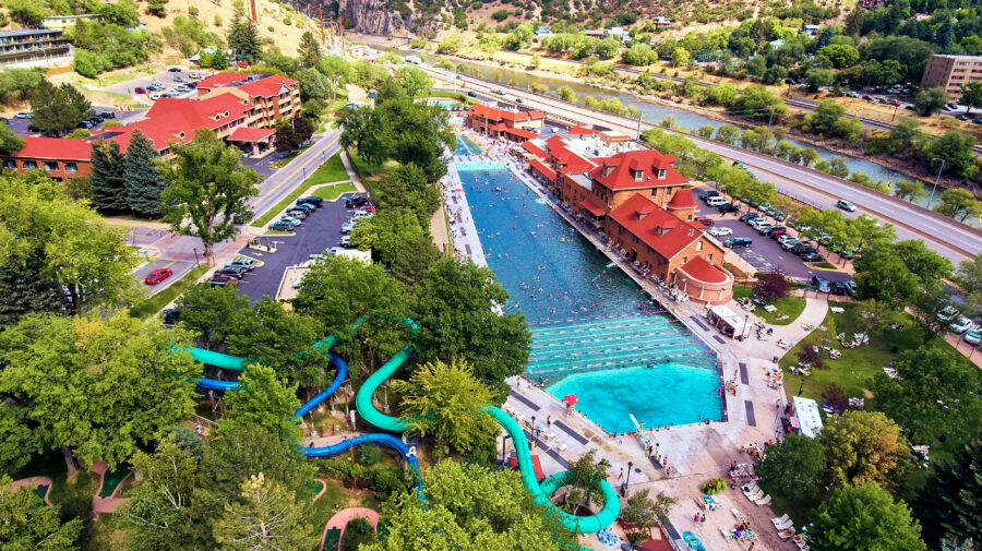 Aerial view of Glenwood Springs Hot Springs, surrounded by the expansive Rocky Mountains in the background