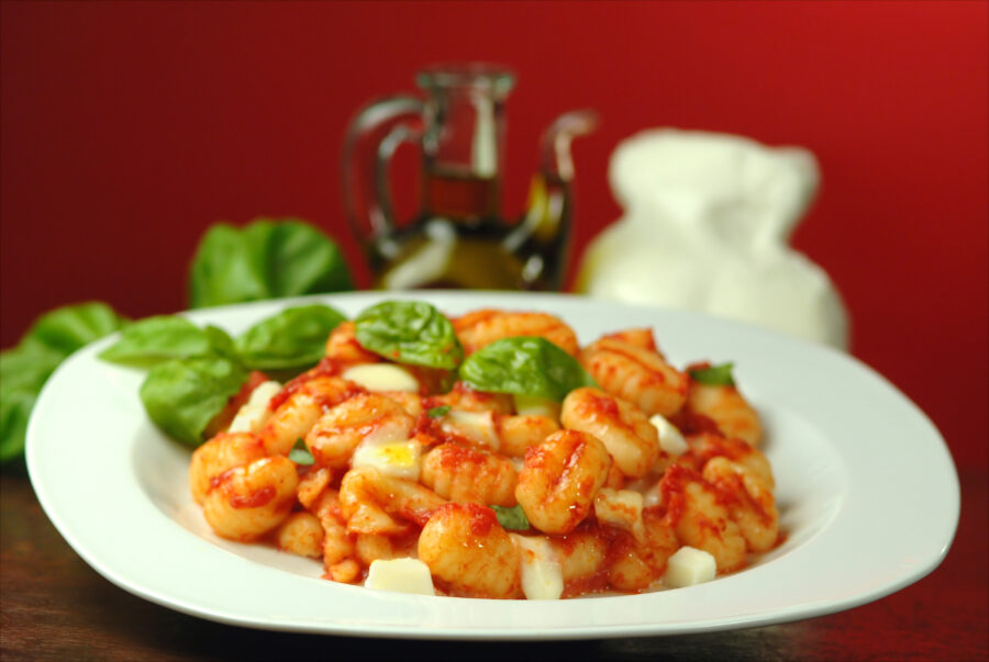Close-up image of Gnocchi alla Sorrentina, highlighting the creamy texture of gnocchi in a savory tomato and cheese sauce