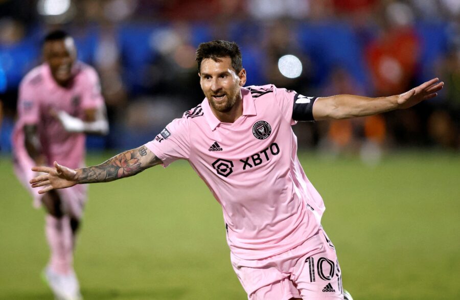 Lionel Messi goal celebration, Inter Miami, vibrant pink jersey, XBTO sponsor, soccer stadium excitement.
