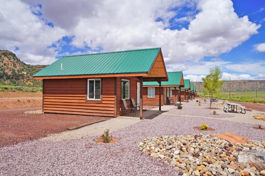 Gooseberry Lodges cabin featuring a green roof and a gravel driveway, set in the scenic Zion National Park area.
