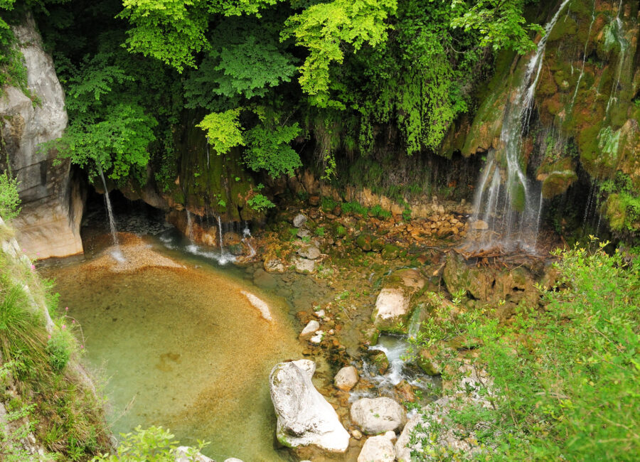 Beautiful long exposure of the Cascades du Saut du Loup in Gorges du Loup, Provence, captured on a sunny summer day.