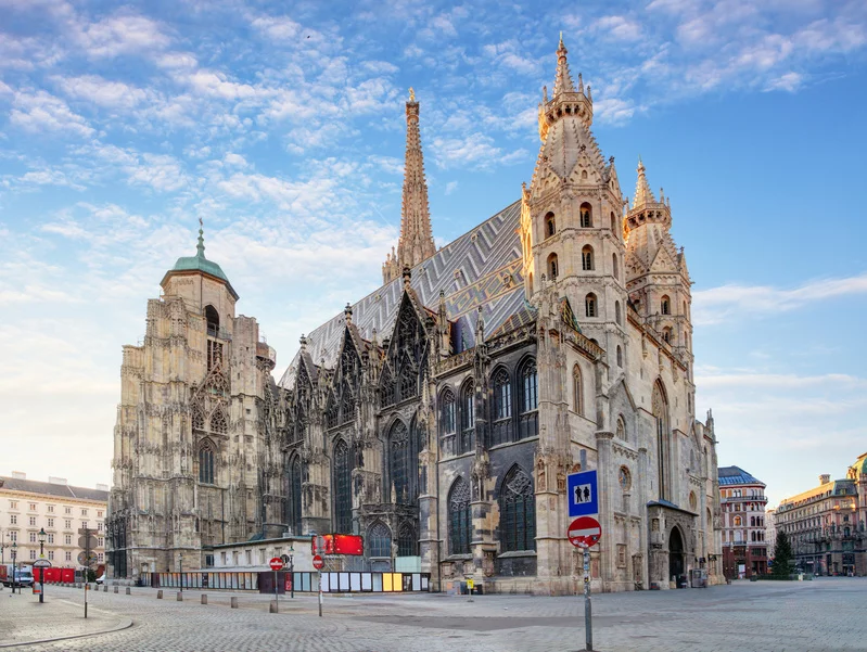 Gothic St. Stephens Cathedral in Vienna with colorful mosaic roof and spires.