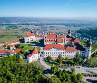 Scenic view of Göttweig Abbey above the Danube Valley, showcasing its architecture against a backdrop of rolling hills