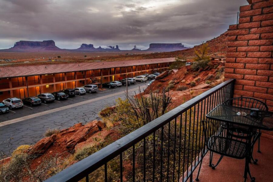Balcony view at Goulding's Lodge showcasing the iconic red rock formations of Monument Valley under a clear blue sky.