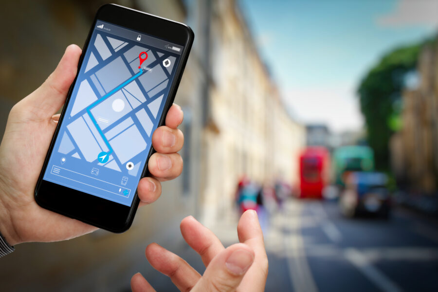 Close-up of a tourist using a smartphone GPS app for navigation, displaying a map with directions.