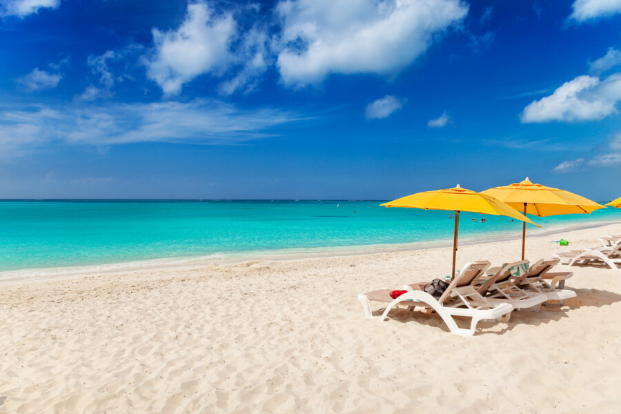 Grace Bay Beach, Turks and Caicos, with white sand and crystal-clear waters under a sunny blue sky