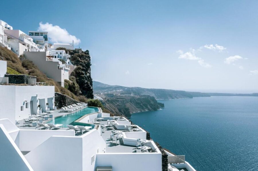 Grace Hotel in Santorini, Greece, features elegant white buildings with a backdrop of the Aegean Sea