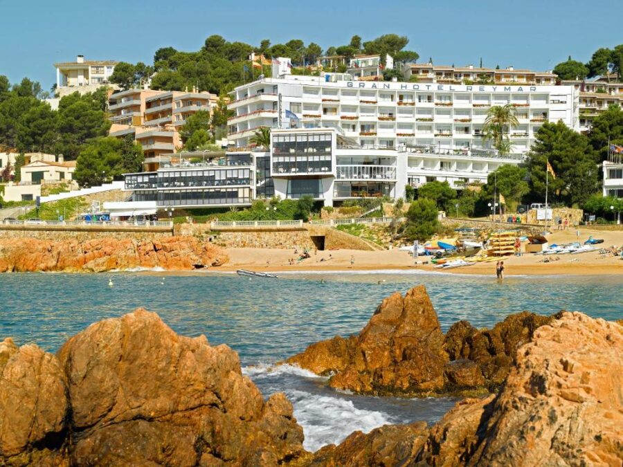 Gran Hotel Reymar, a four-star hotel on the beach in Spain, featuring stunning ocean views and modern amenities.