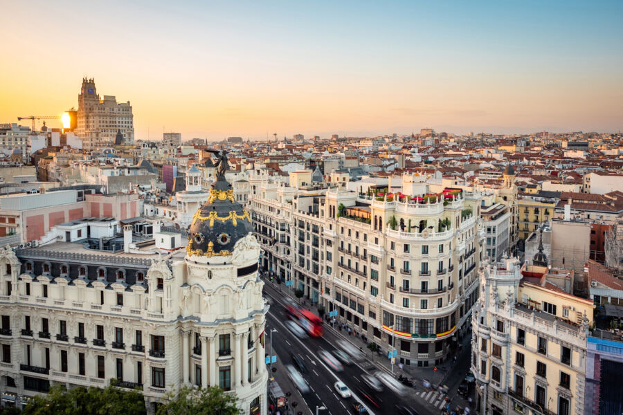 Aerial view of Central Madrid at sunset, highlighting landmark buildings along Gran Via Street