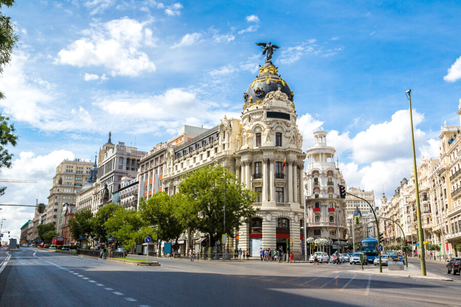Scenic view of Gran Vía street showcasing beautiful architecture in Madrid, Spain, bustling with activity and vibrant atmosphere.