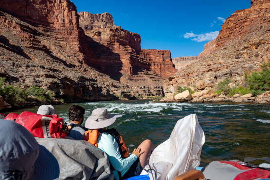 Tourists exploring the Grand Canyon, marveling at its vast landscapes and unique rock formations during their expedition