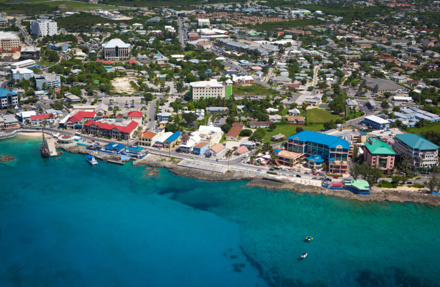 Aerial view of the coast of Grand Cayman, Cayman Islands, showing crystal-clear waters and white-sand beaches