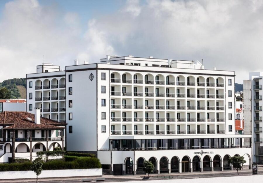 Grand Hotel Açores Atlântico on a street in Portugal, showcasing its inviting exterior and surrounding urban landscape.