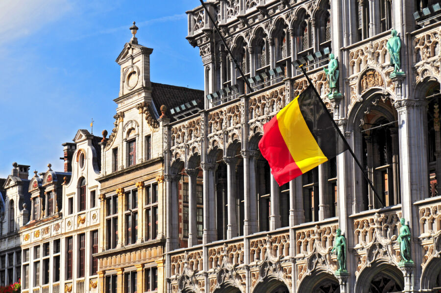 The Broodhuis at Grand Place, Brussels, showcasing intricate design with a flag prominently displayed