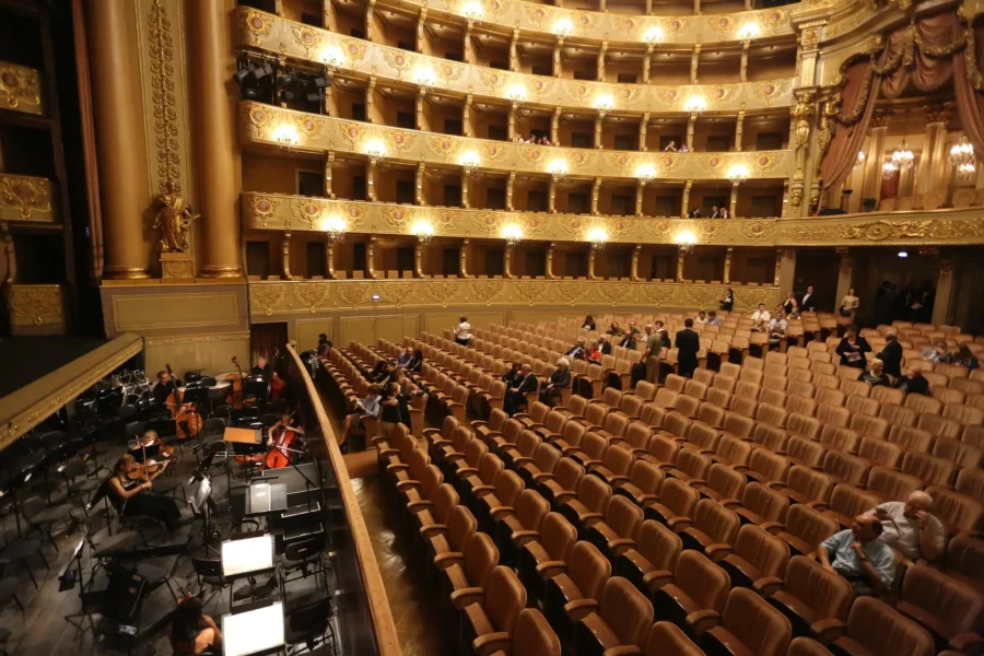 Teatro Nacional de São Carlos Lisbon interior with orchestra pit, plush seats, gilded boxes.