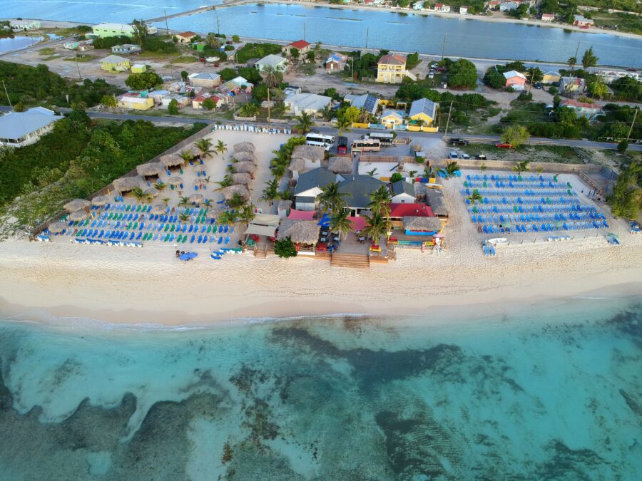 Aerial view of Grand Turk resorts along the shore, featuring private white beaches and turquoise waters of Turks & Caicos