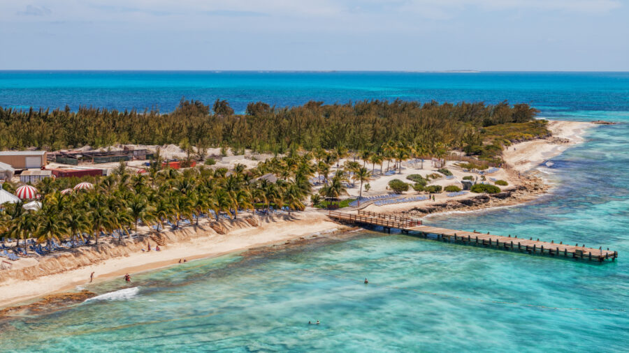 Aerial view of the beach at Grand Turk's cruise center, showcasing turquoise waters and sandy shores in the Caribbean.